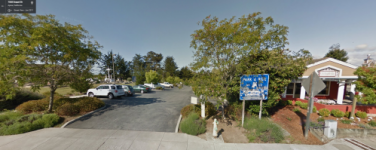 Photo of entrance to Resurrection Church Park and Ride lot next to church cemetery